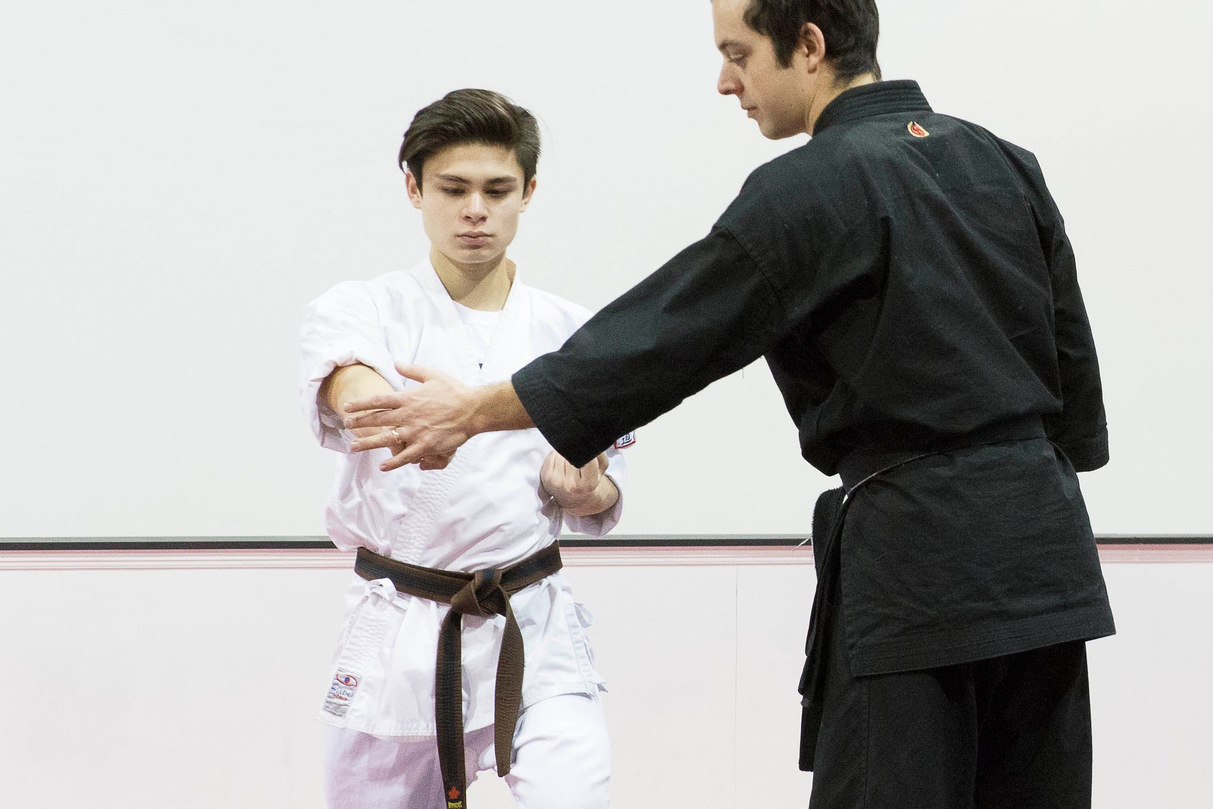 Instructor teaching an adult self-defense technique